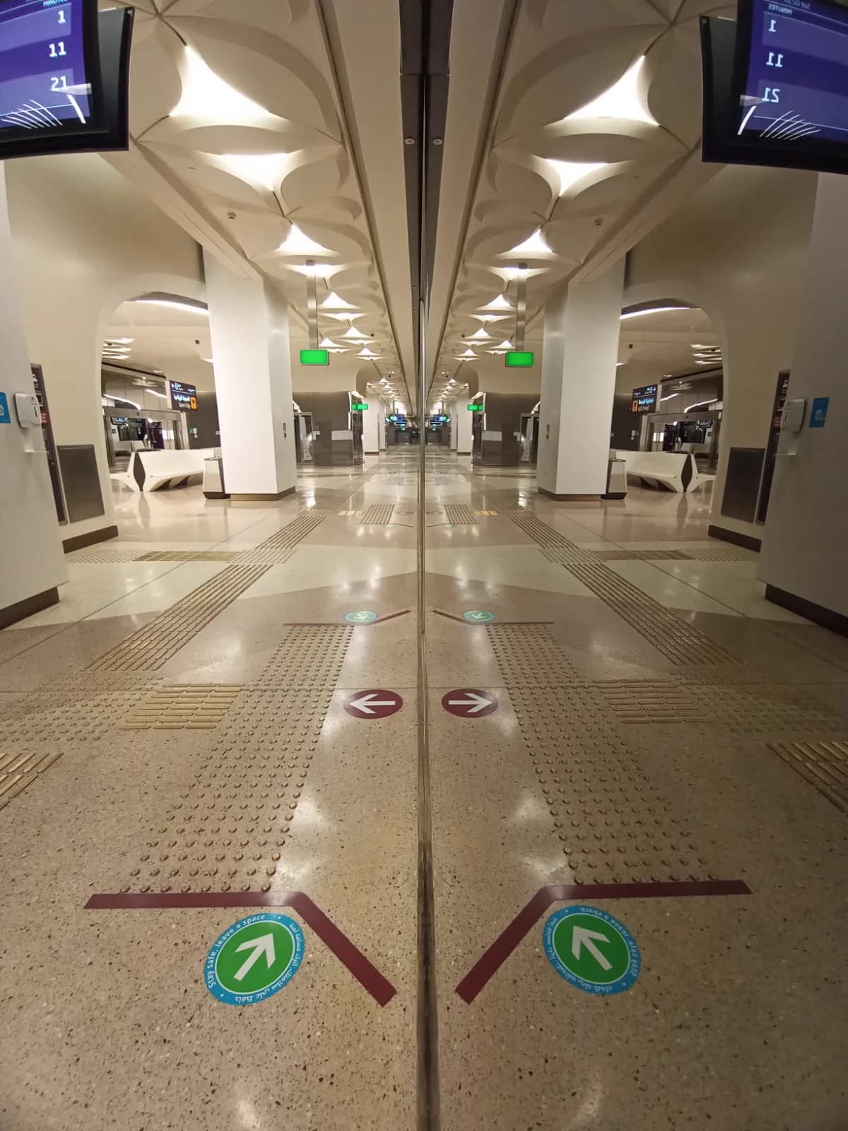 Doha Metro concourse with tactile warning indicators, directional floor graphics and polished terrazzo flooring