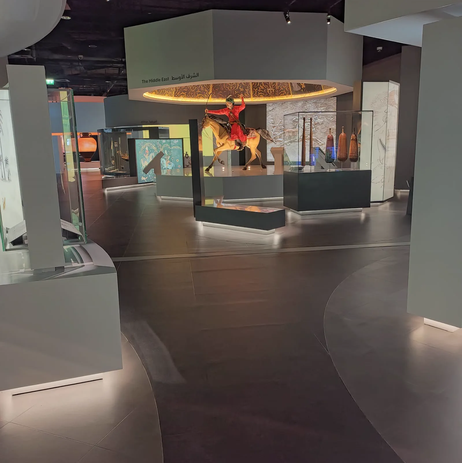 Museum exhibition gallery in Doha with dark seamless rubber flooring running between illuminated display cases